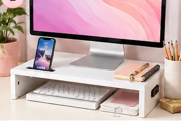 White monitor riser with phone holder organizing a home office desk